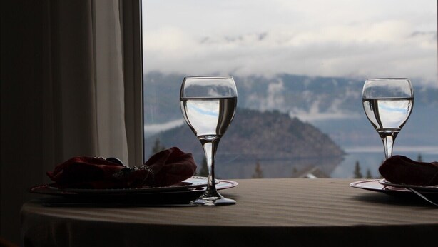 Two wine glasses on a table by a window with a mountain view. - Selah Retreat Guesthouse B&B -  "Defining Tranquility, Beauty and Excellence!" (Sorrento)