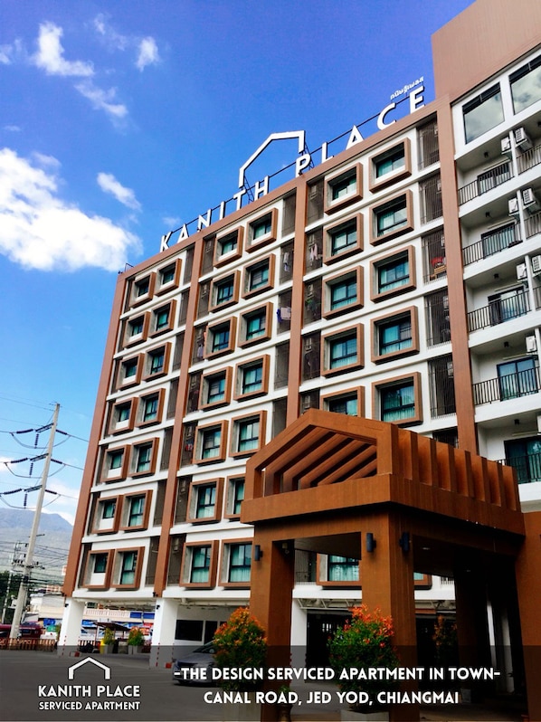A multi-story serviced apartment building named "KANITH PLACE" with a modern architectural design, located on Canal Road in Jed Yod, Chiang Mai.