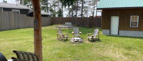 Large fenced yard with BBQ, firepit, chairs and picnic table