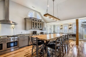 Enjoy cooking in this kitchen with a spacious island, stainless steel range, and large window.