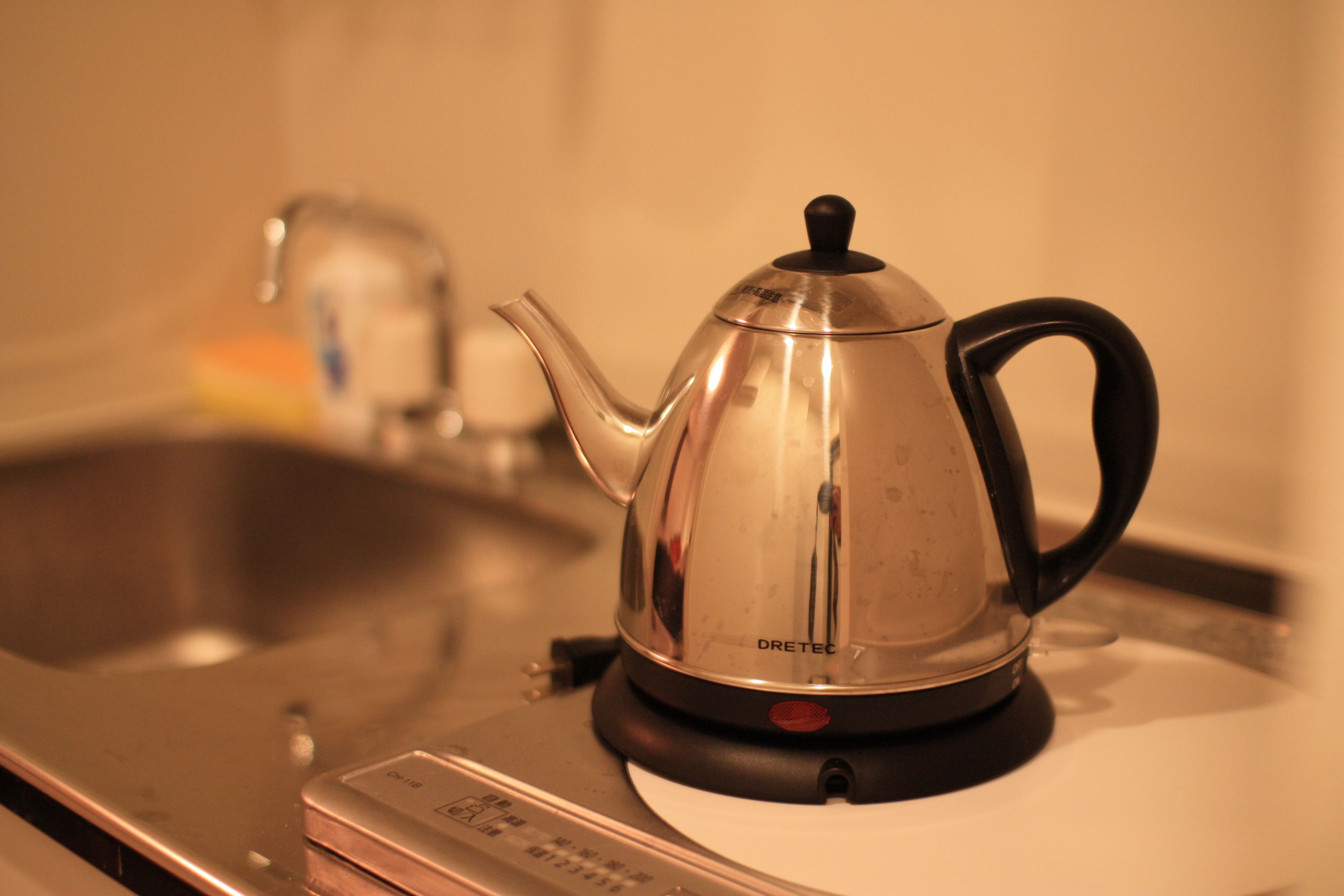 A stainless steel electric kettle on a kitchen counter.