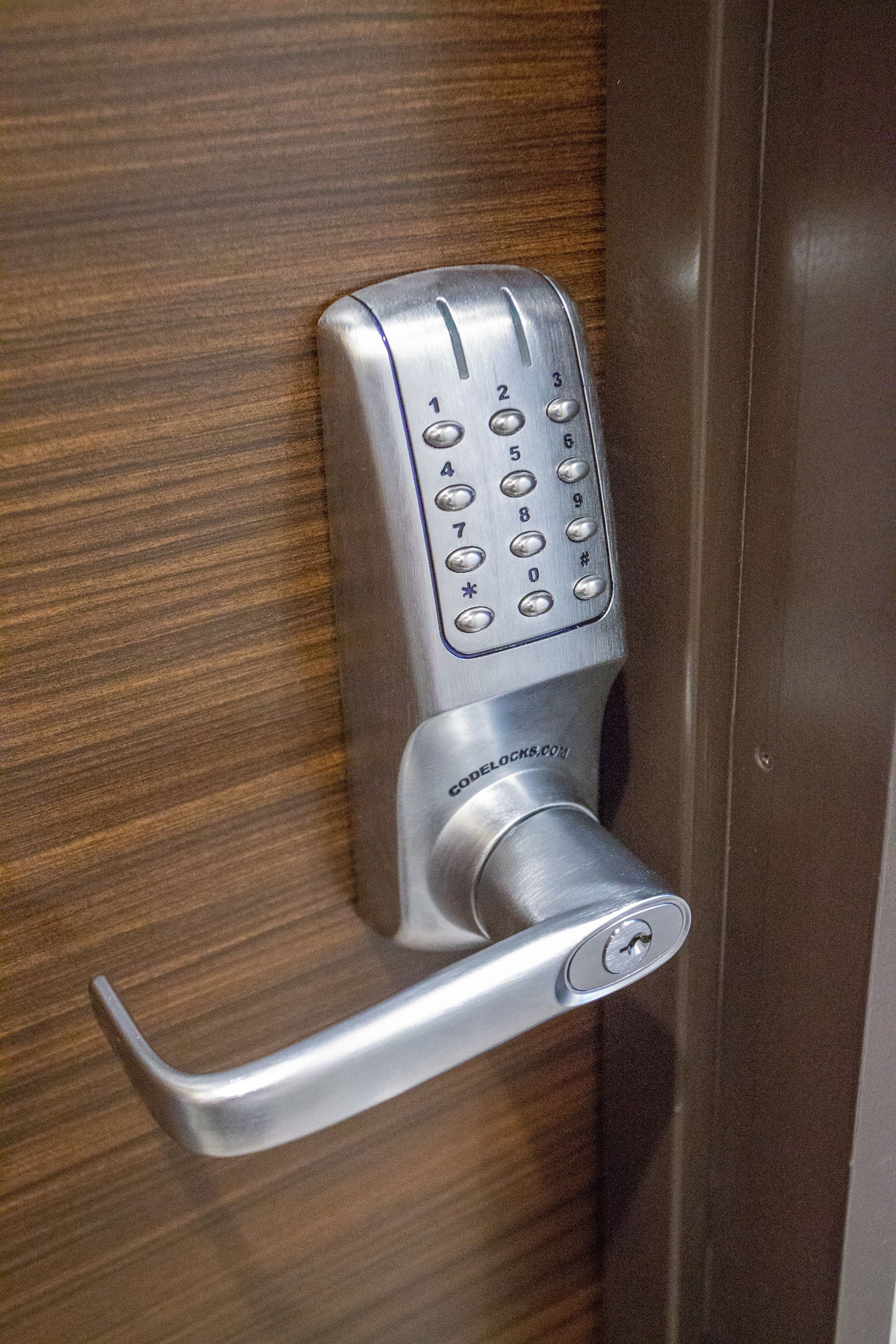 A modern door lock with a numeric keypad and a keyhole.