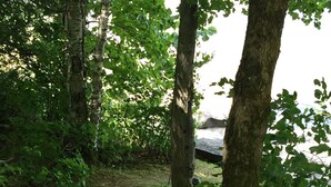 A wooden staircase leading up a hill, surrounded by trees and greenery. - West Facing Private Cottage Oasis On Beautiful Isabella Lake Near Parry Sound (Parry Sound)