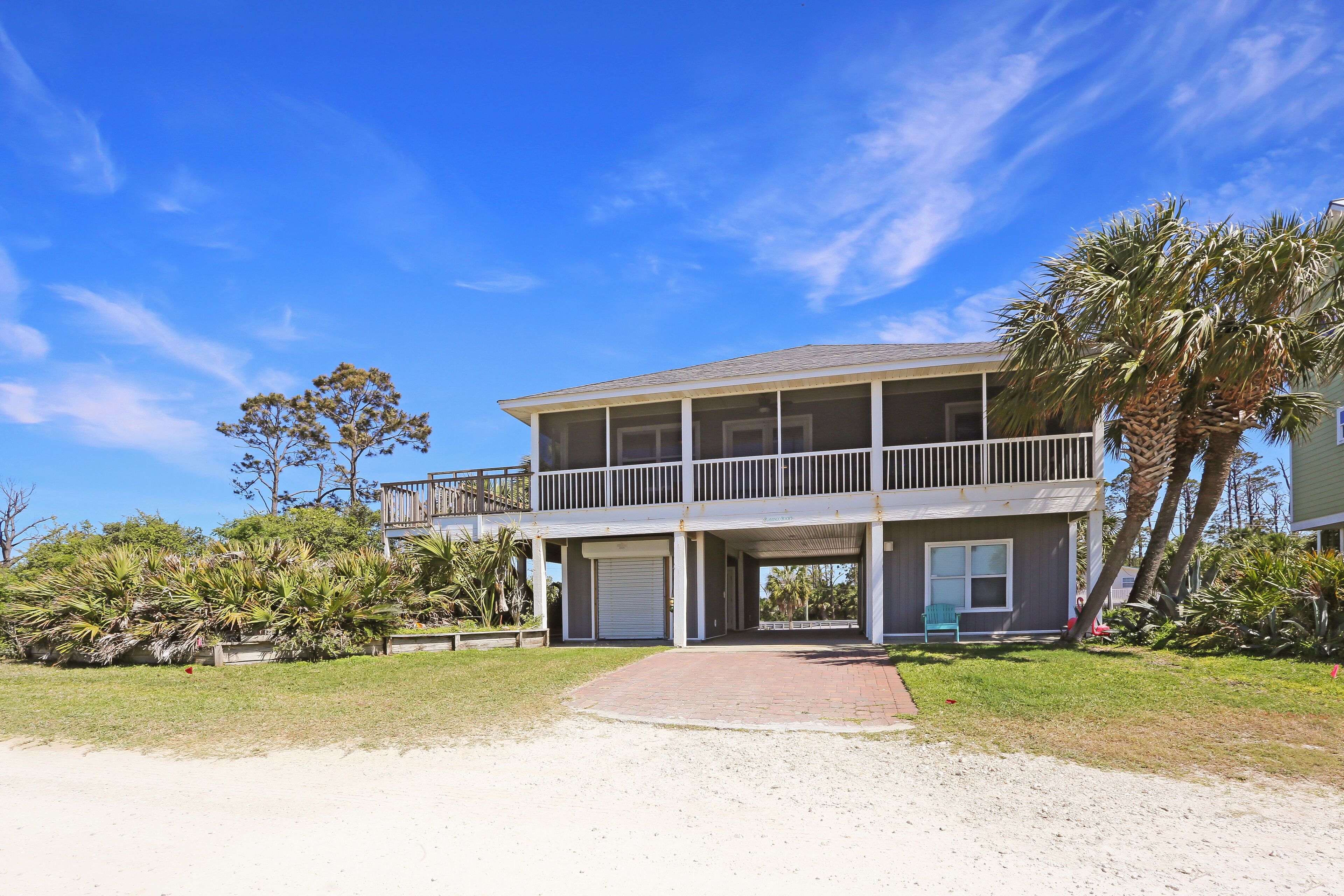 A two-story building with a covered front porch and a balcony.