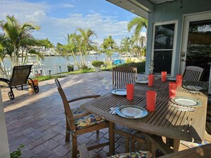 Outdoor dining - Waterfront Luxury Oasis - Steps to Beach     
 - Kayaks, Private Dock & Patio 🏖 (Indian Rocks Beach)