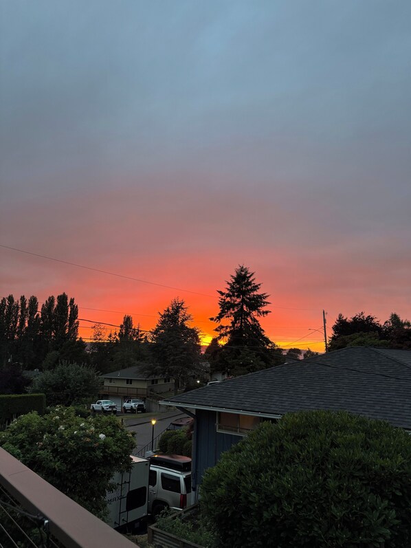 A residential area with houses, a parked van, and a sunset. - Upper Level with a view close to Boeing (everett)