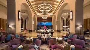 A spacious lobby with a central chandelier, seating areas, and a reception desk. - Doubletree by Hilton Qingdao Oriental Movie Metrop (Qingdao)