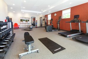 A gym with treadmills, elliptical machines, a bench, and free weights. - Home2 Suites by Hilton Smithfield, RI (Smithfield)