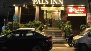 A building with a sign reading "PALS INN" at the entrance. - Pals Inn (New Delhi)