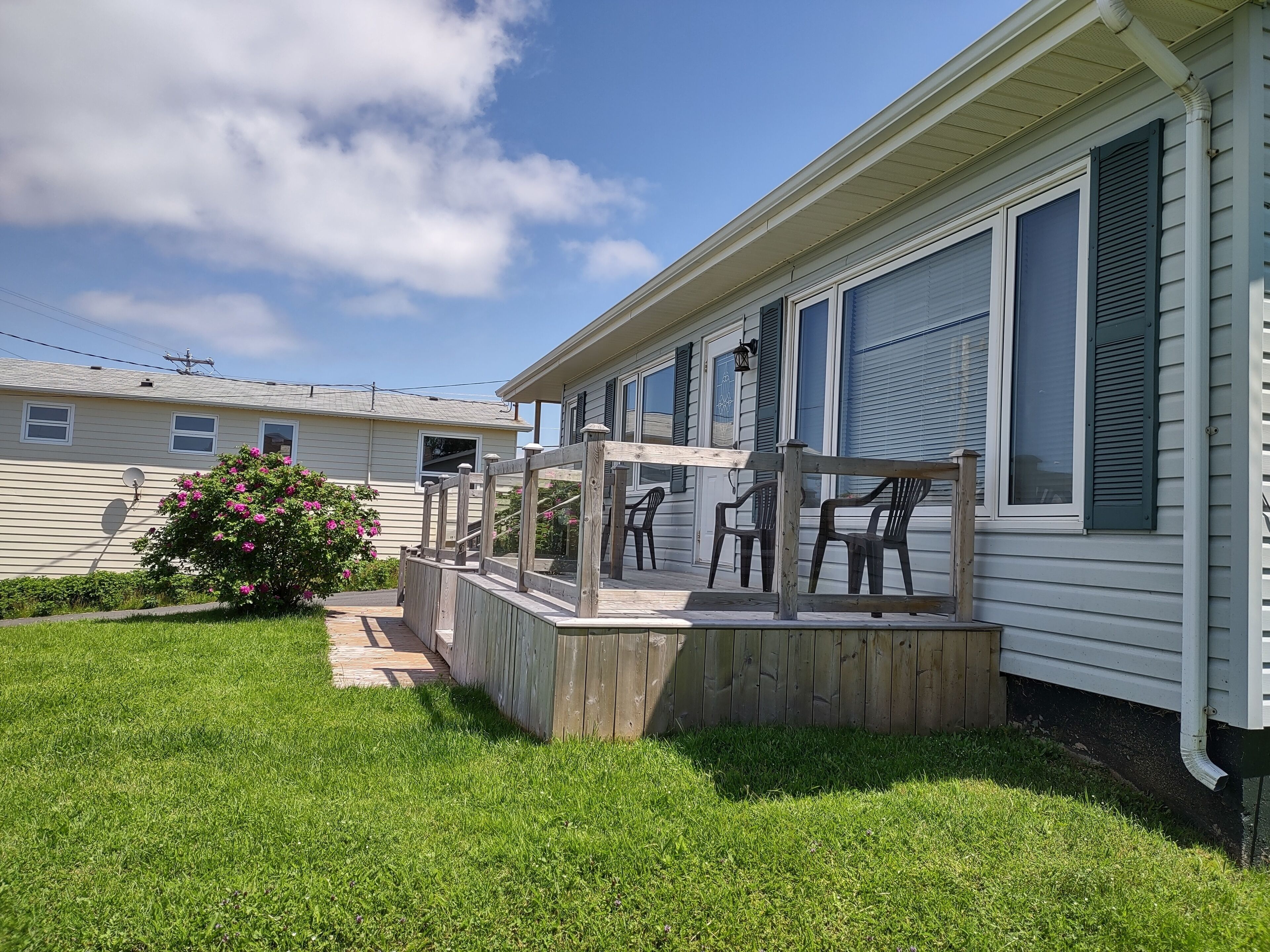 A single-story house with a covered porch and outdoor seating.