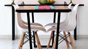 A dining area with a table, chairs, and a large botanical print on the wall. - Plantation House (Hikkaduwa)
