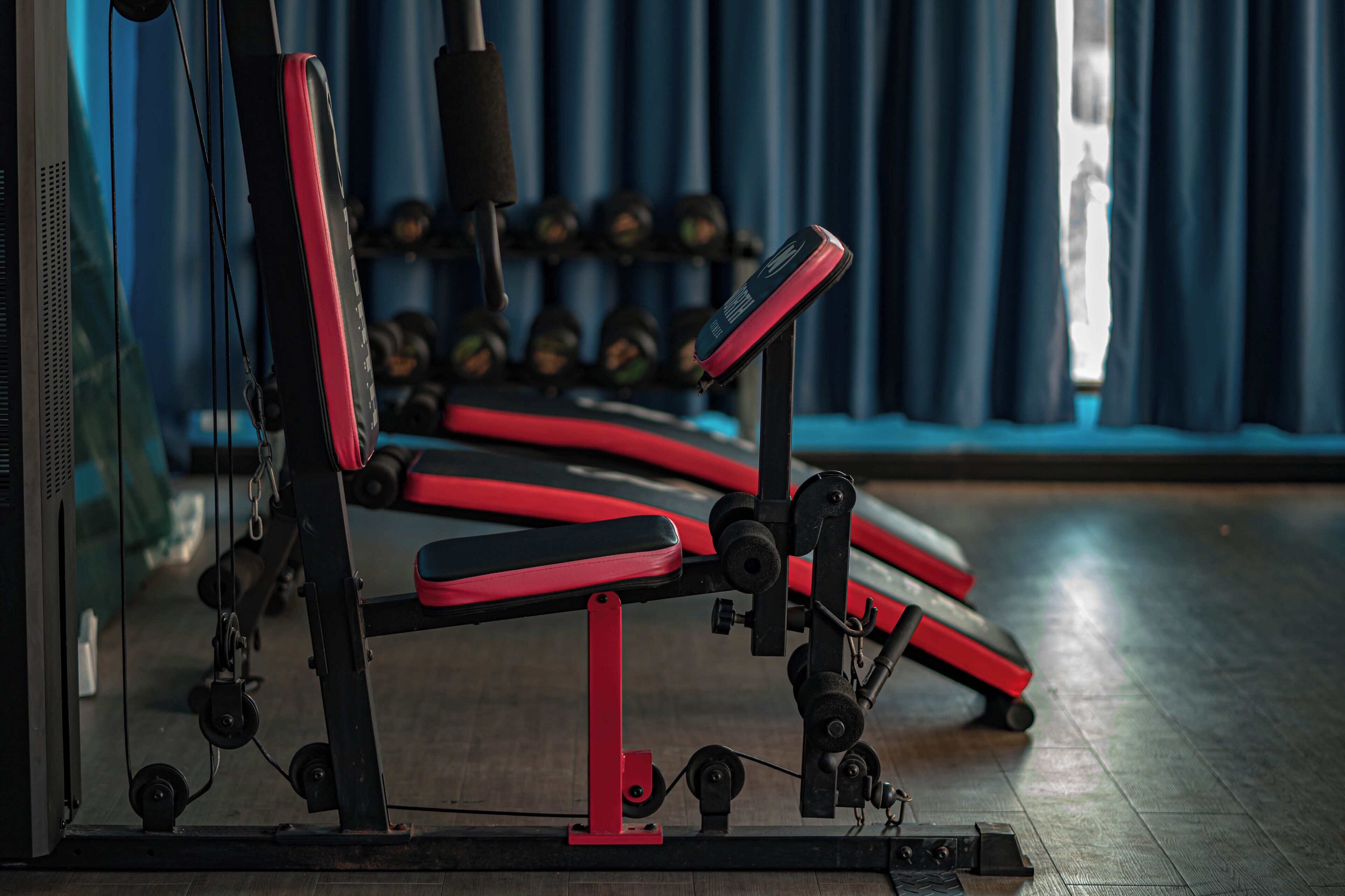 A gym with exercise equipment, including benches and dumbbells.