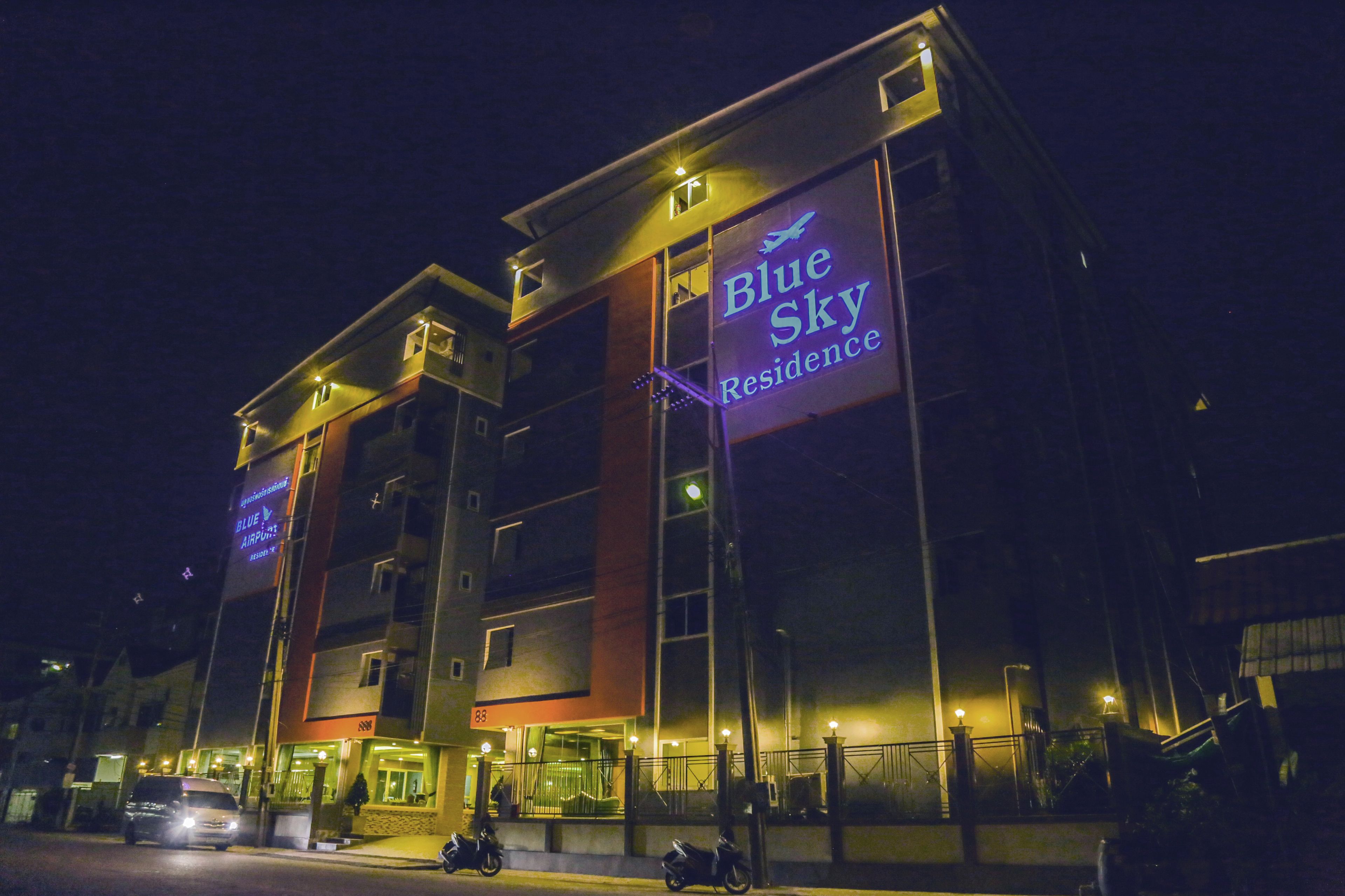 A multi-story hotel with a prominent sign reading "Blue Sky Residence."