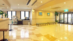 A spacious lobby with a check-in counter, seating area, and a large window. - Koga Ark Hotel (Koga)