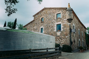 Un bâtiment en pierre doté d’un toit en pente et d’une petite tour.