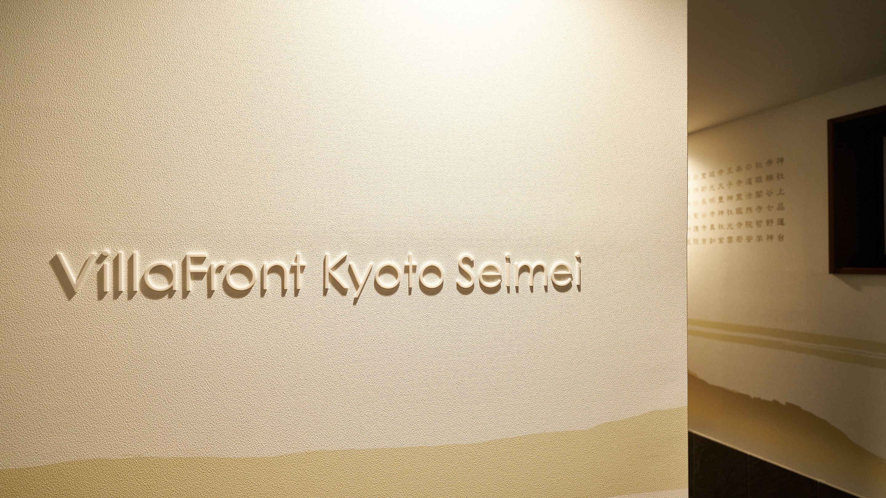 A textured wall with the inscription "VillaFront Kyoto Seimei".