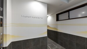 A modern elevator interior with a digital display, a handrail, and a wall-mounted control panel. - Villa Front Kyoto Seimei (Kyoto)