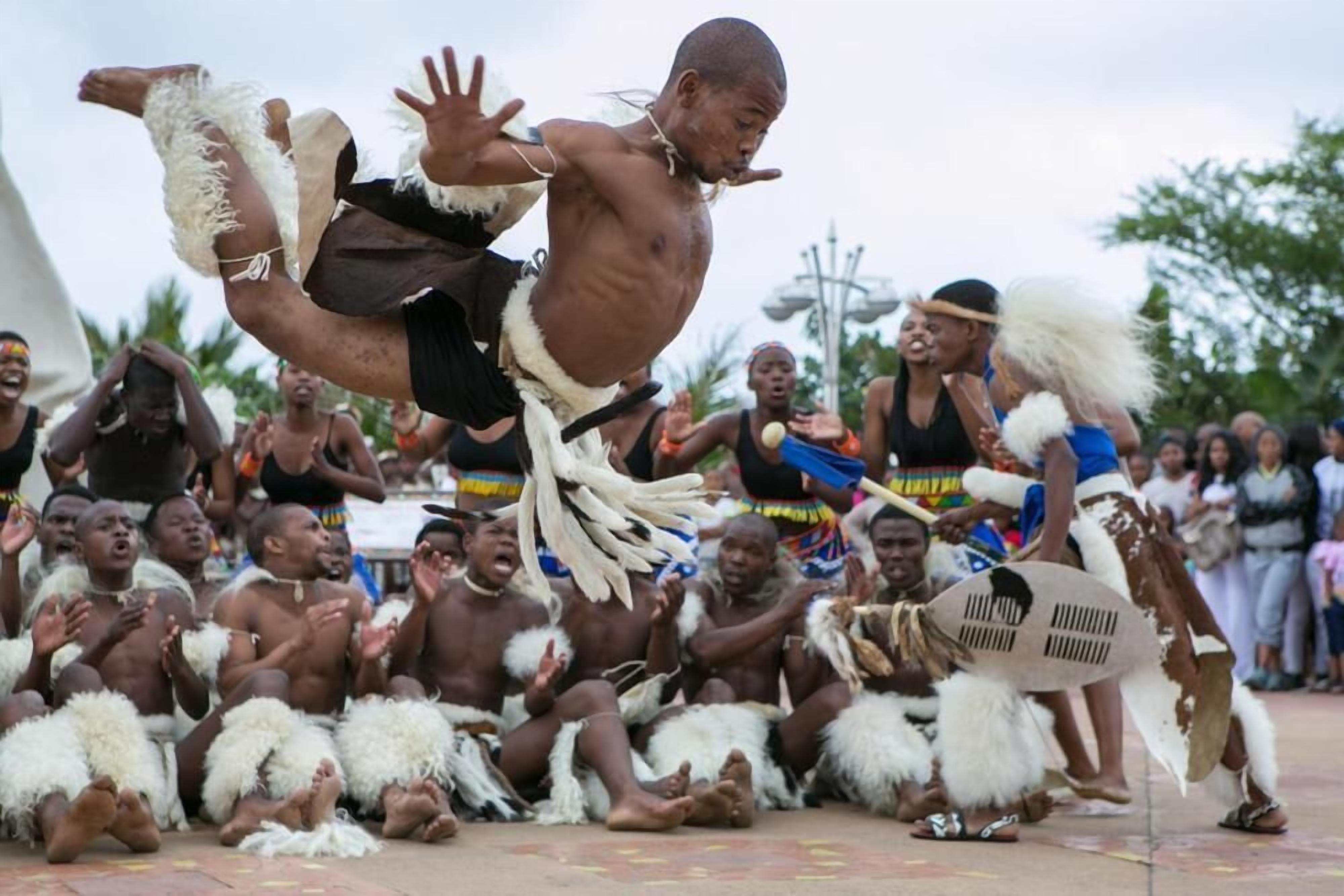 A group of people in traditional attire performing a dance.