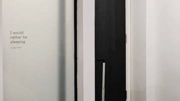 Two doors lead to separate accommodations in this stylish hallway with a modern aesthetic.