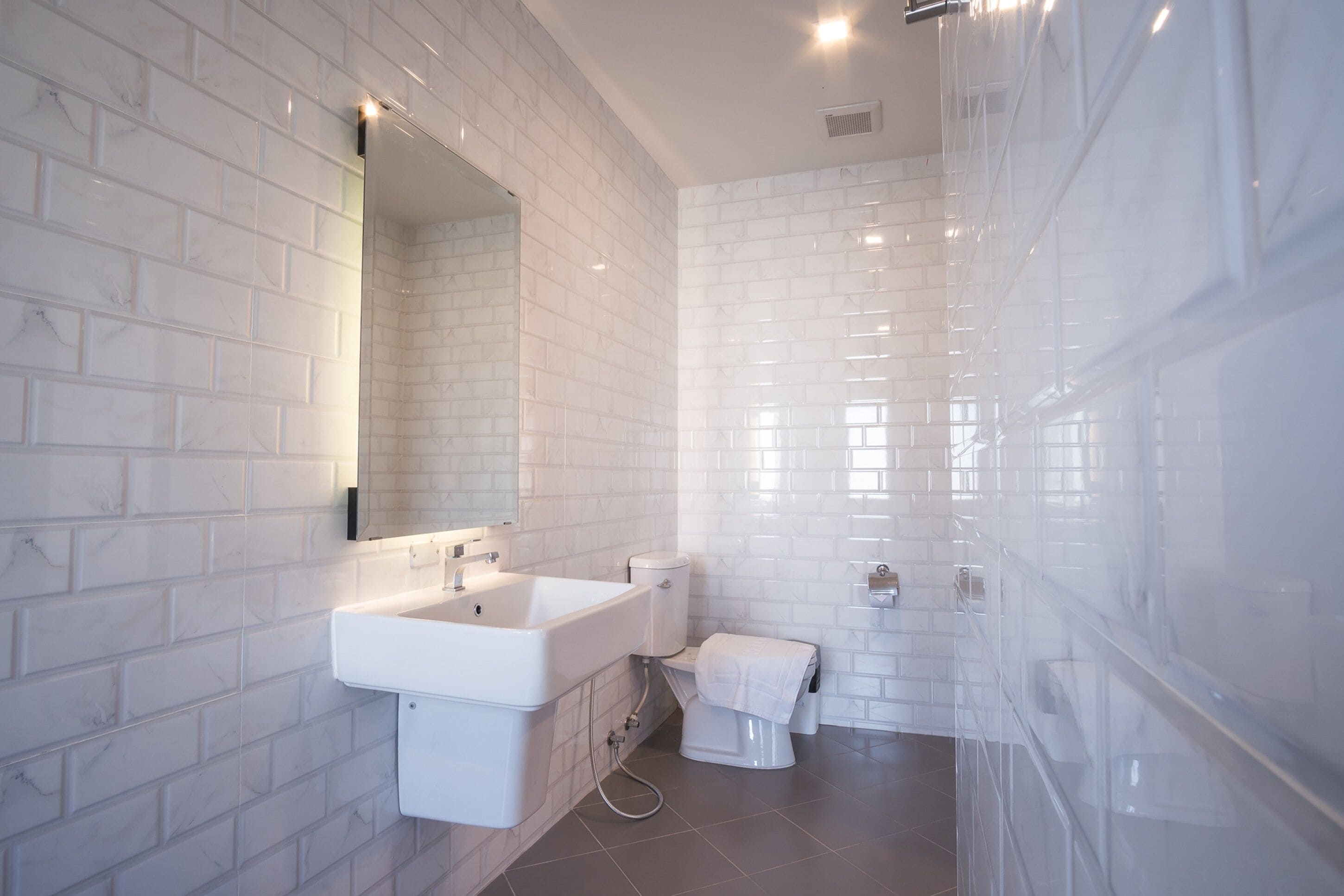 family room for 3 | bathroom | shower, rainfall showerhead, hair dryer, towels