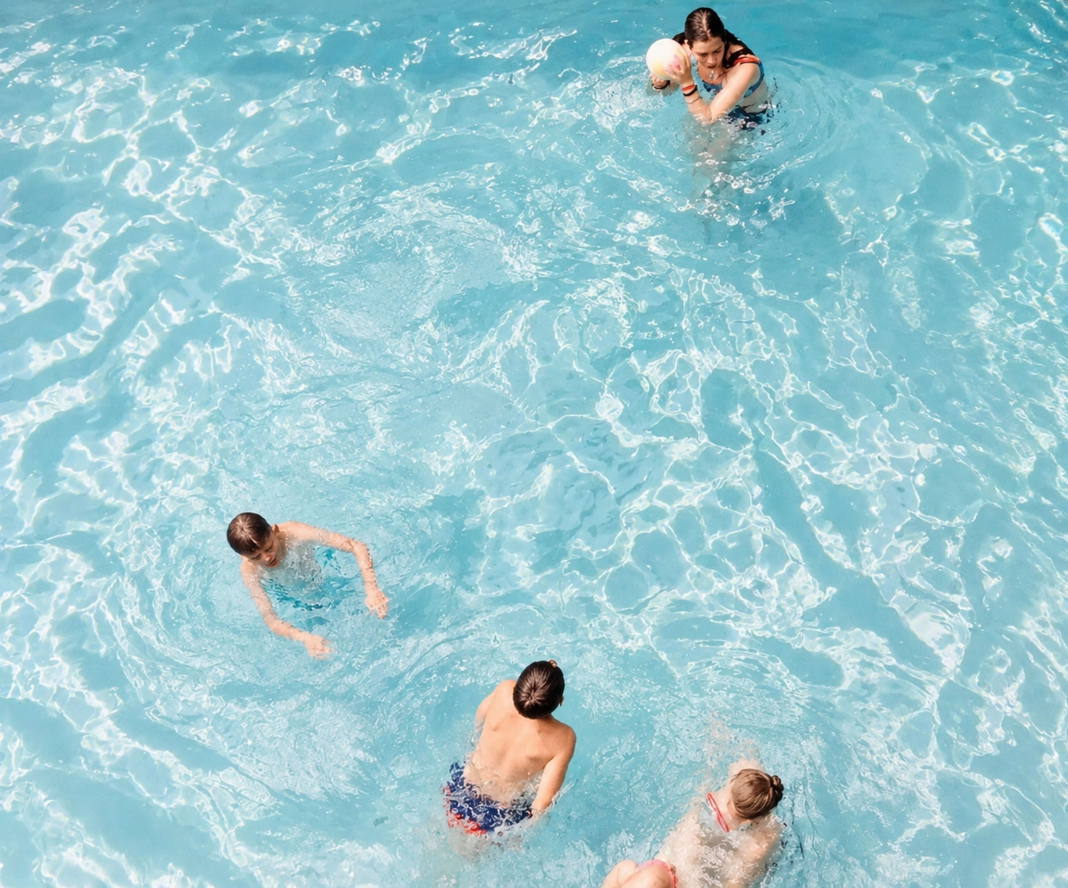 A swimming pool with clear water and visible ripples.