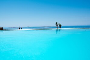 An infinity pool, pool loungers