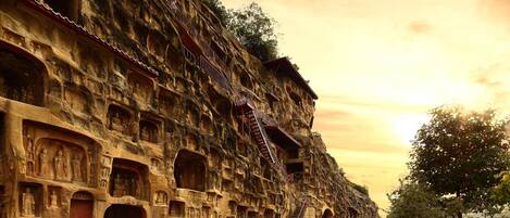 A large, multi-level stone structure with numerous niches and staircases.