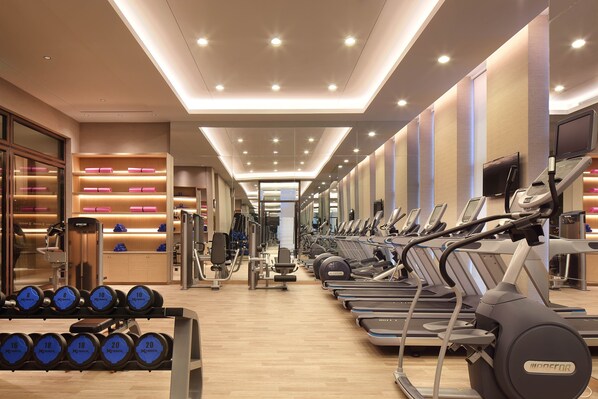 A gym with treadmills, dumbbells, and weight machines. - Wanda Realm Guangyuan (Guangyuan)