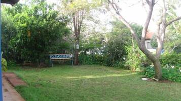 A garden area with a bench and a signboard.