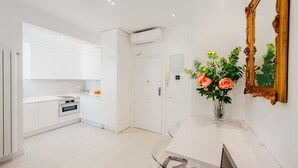 A modern kitchen with white cabinetry, a built-in oven, and a white countertop. - The Viso Smart III (NEW) (Madrid)