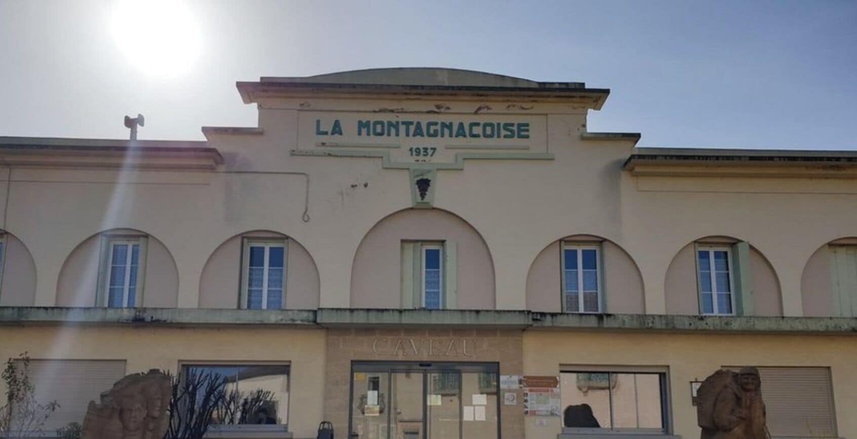 A building with the sign 'LA MONTAGNACOISE 1937' and a café entrance.