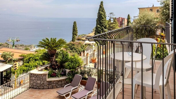 A balcony with a view of the sea, outdoor seating, and potted plants. - [Le Grand Bleu] - Villa Maremonti Taormina (Taormina)