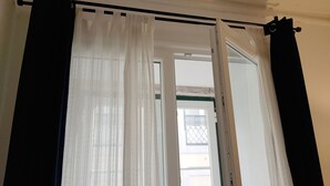 A room with a window featuring sheer white curtains and a black valance. - Cozy Palace in Lisbon for 2 to 6 people (Lisboa)