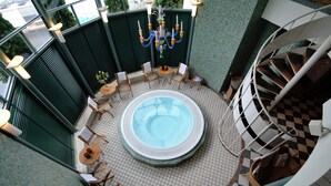 A rooftop pool area with a hot tub, lounge chairs, and a staircase. - Söderköpings Brunn (Soderkoping)