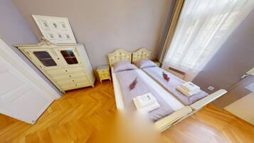 Un dormitorio con una cama doble, un tocador y una mesita de noche.