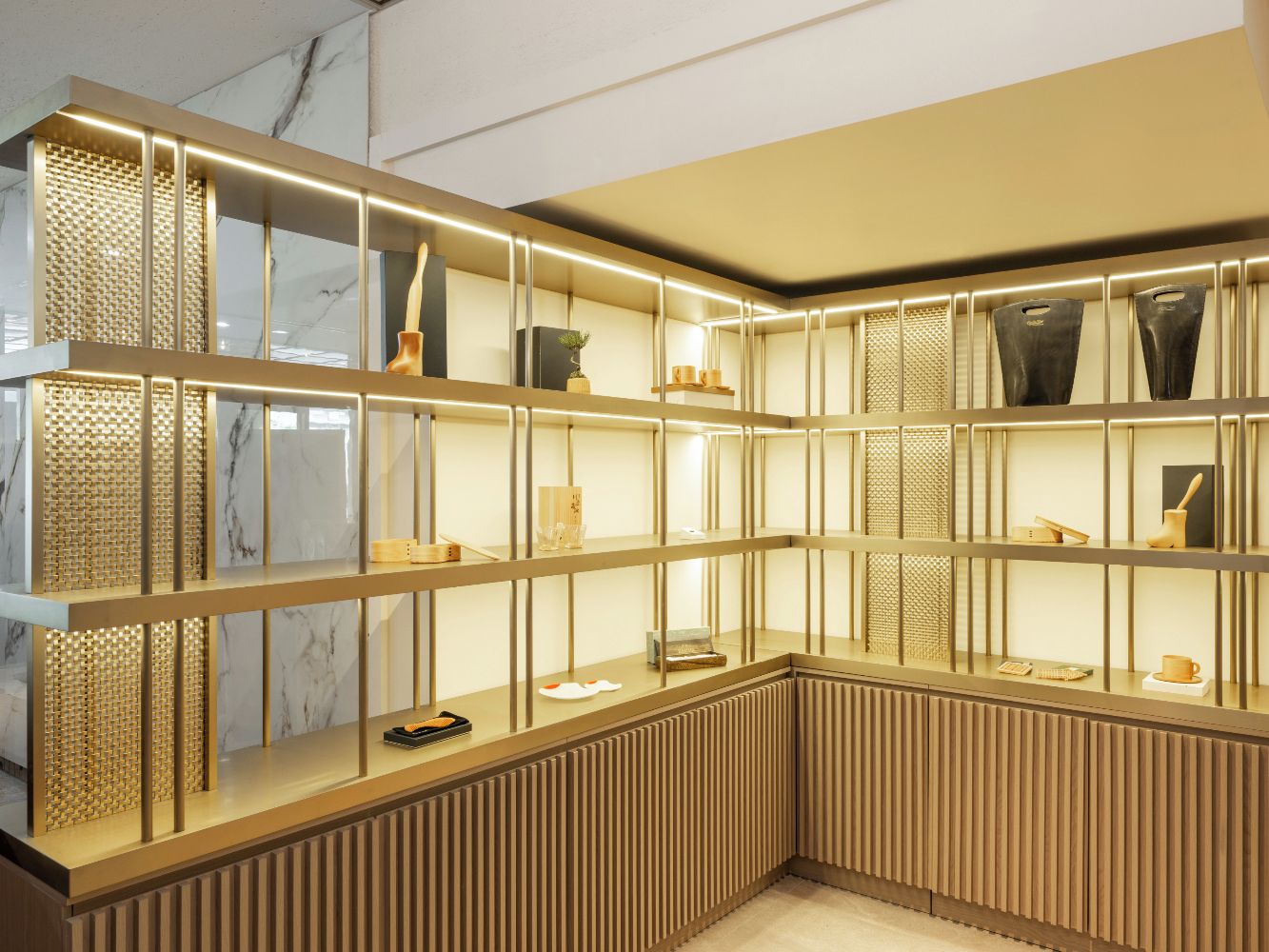 A corner room with a built-in shelving unit, a marble wall, and a wooden panel design.