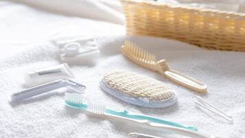 A bathroom with a white towel, a wicker basket, and various toiletries.
