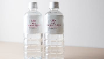 Two bottles of water labeled 'ANA CROWNE PLAZA HOTELS & RESORTS' with a leaf pattern on the label.