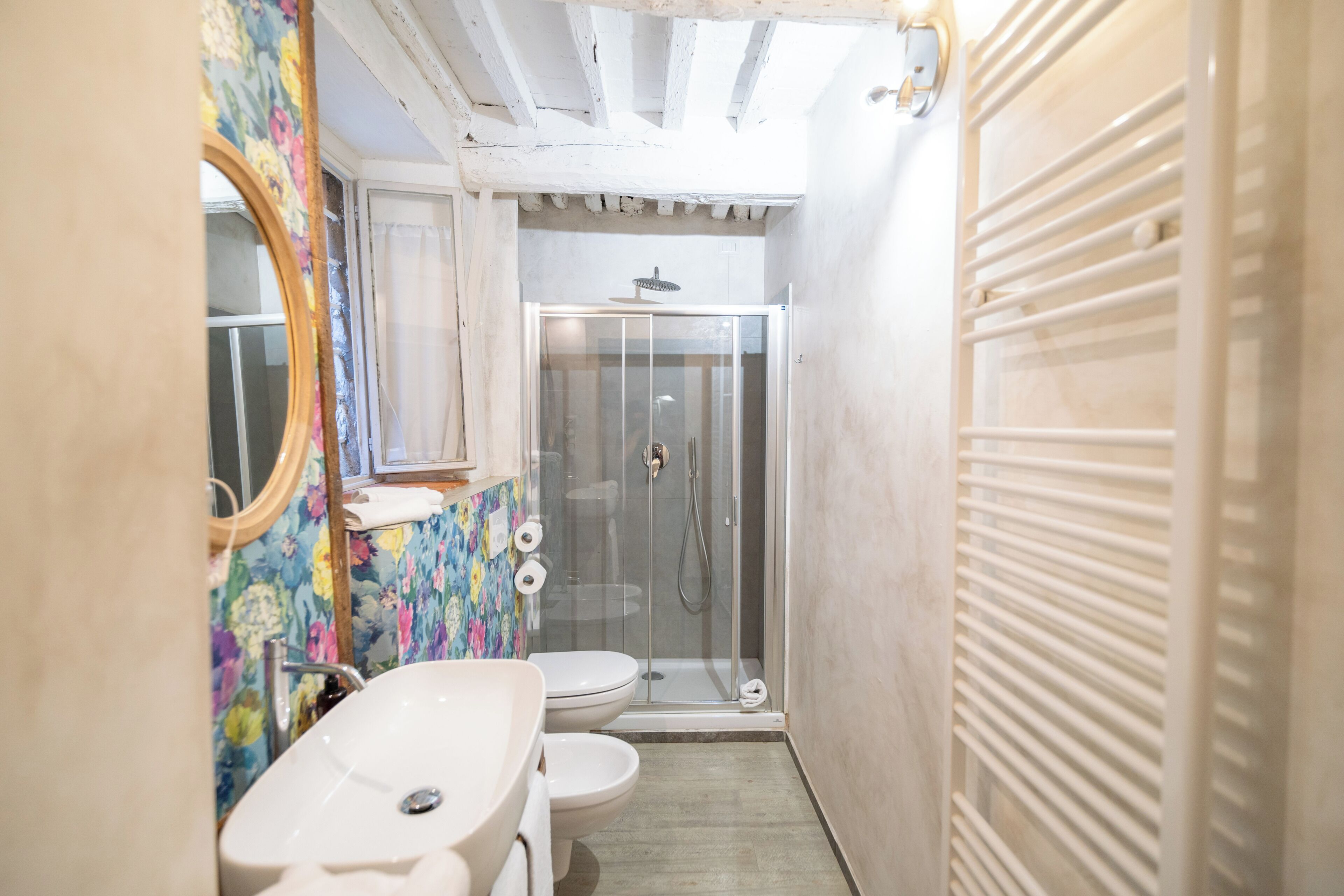 A bathroom with a shower, toilet, and sink.