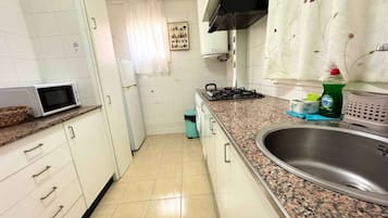 Fridge, microwave, oven, cookware/dishes/utensils