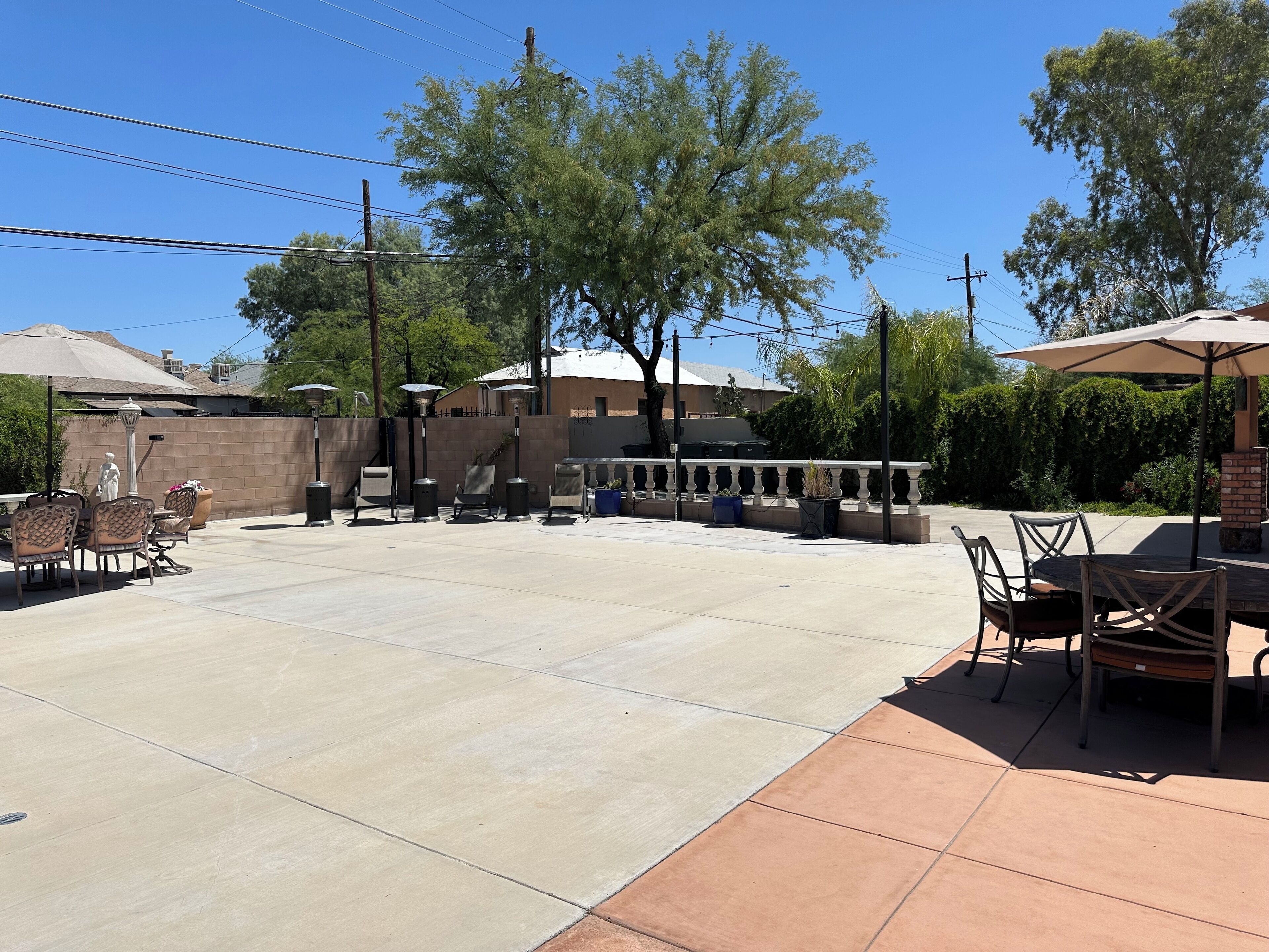 A patio area with outdoor furniture, a barbecue grill, and a covered seating area.