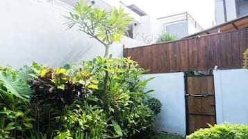 Un jardín con diversas plantas y una valla de madera.