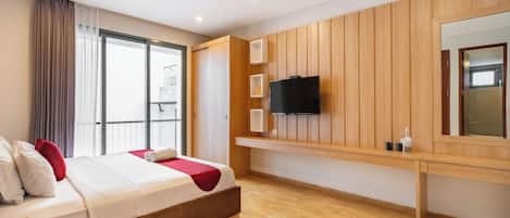 A modern hotel room with a large bed, a TV mounted on the wall, and a balcony with a view.