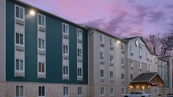 A multi-story hotel with a stone facade and a flat roof.
