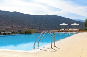 Seasonal outdoor pool, an infinity pool, pool loungers
