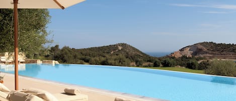 Seasonal outdoor pool, an infinity pool, pool loungers