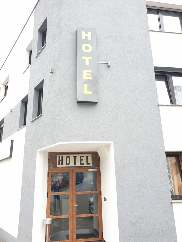 A hotel sign with the word "HOTEL" in large letters on a grey wall. - Kirchberg Hotel (Saarbrücken)