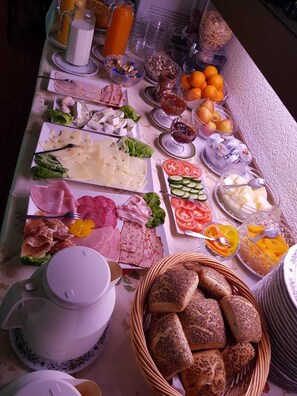 A buffet with various cheeses, meats, fruits, and breads. - Kirchberg Hotel (Saarbrücken)