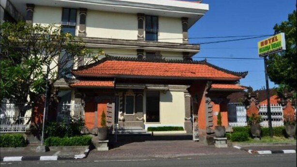 A two-story building with a traditional tiled roof and a sign indicating it is a hotel. - Hotel Nuansa Indah (Denpasar)