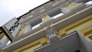 A building facade with a sign reading "GEMINI HOTEL" and decorative architectural elements. - Hotel Gemini (Düsseldorf)